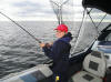 Brandon Coron reeling in a Lake Trout