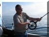 Harri Hallamaa reeling in a Lake Trout